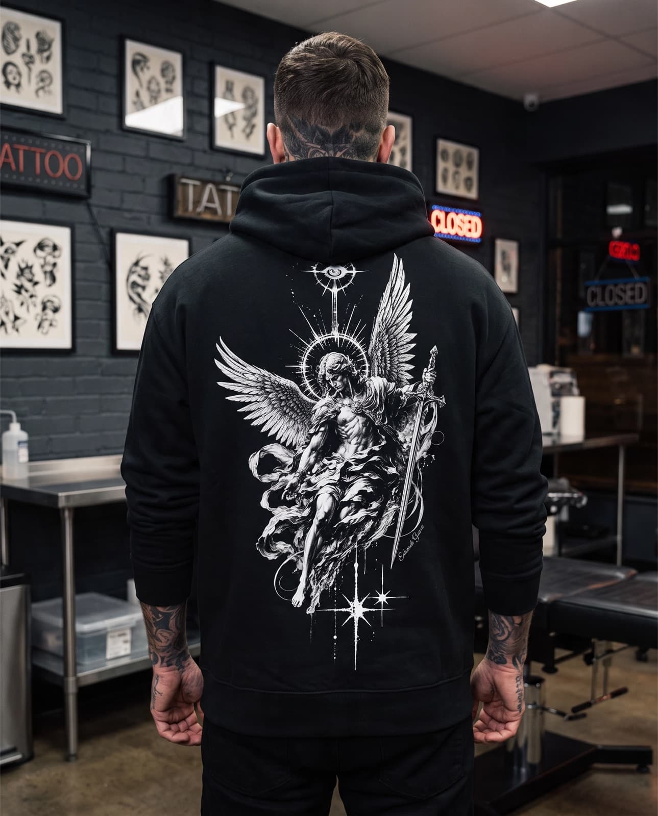 Tattooed model wearing the Eduardo Gomez Celestial Warrior Black AOP Hoodie from the back