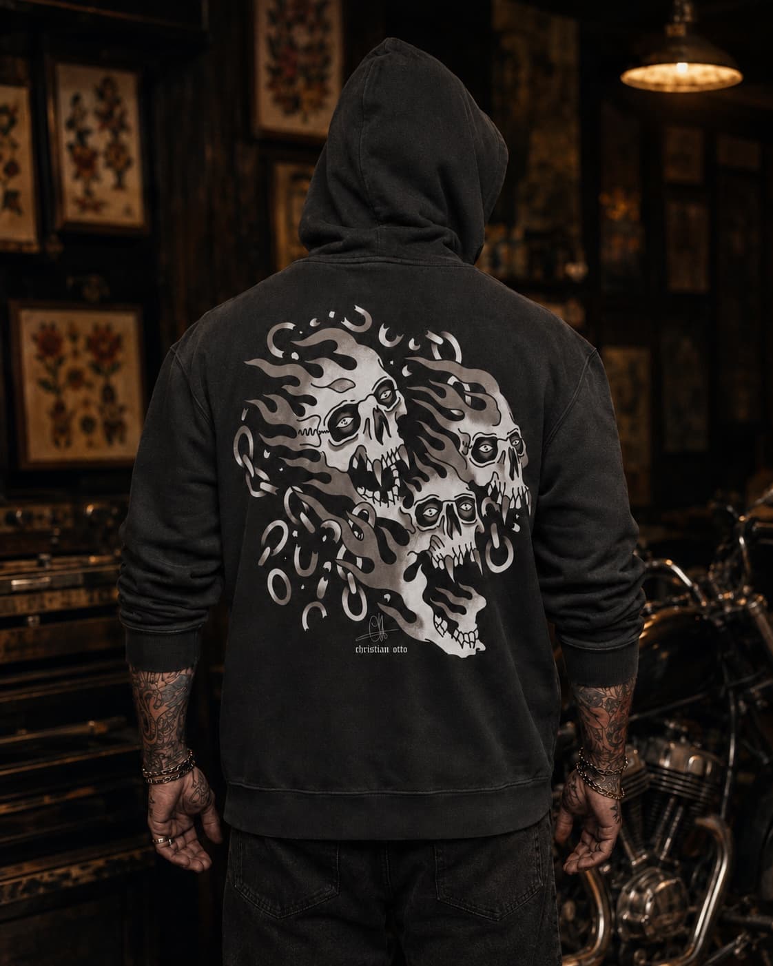 Tattooed model wearing the Christian Otto Signature Skull Black AOP Hoodie shown from the back