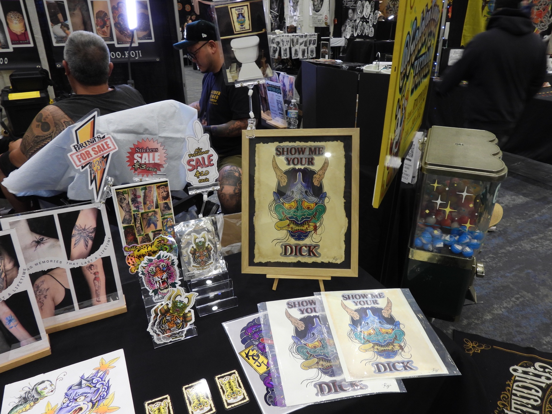 Show Me Your Dick - Altered Flesh Tattoo Convention Display Framed Show Me Your Dick Japanese Oni print surrounded by Altered Flesh Tattoo convention merchandise