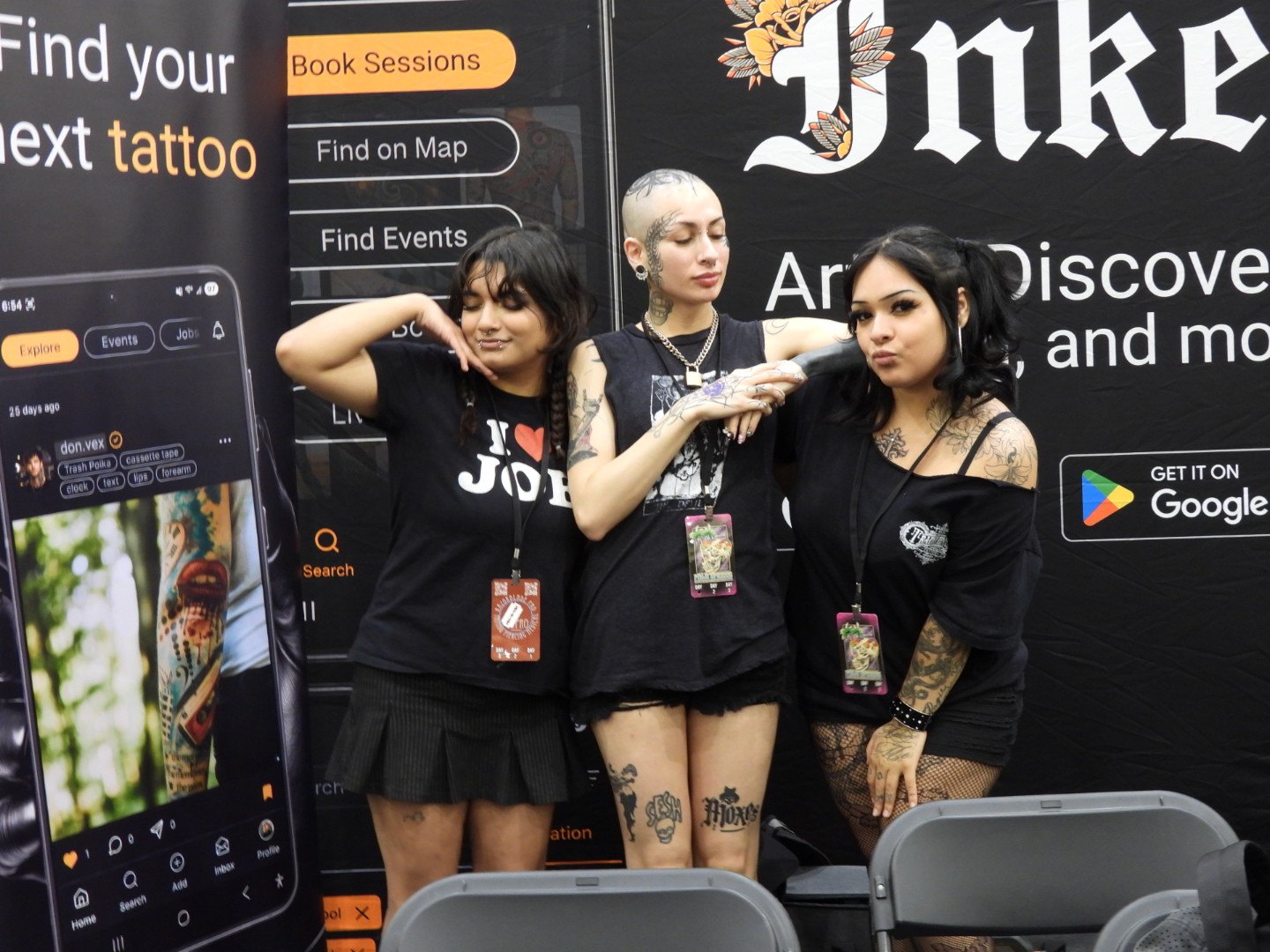 The Convention Opens Long Before the Doors Do — Why Convention Momentum Starts Before Opening Day Three tattoo convention vendors posing near the Inker booth before doors open, capturing the early momentum of a convention floor
