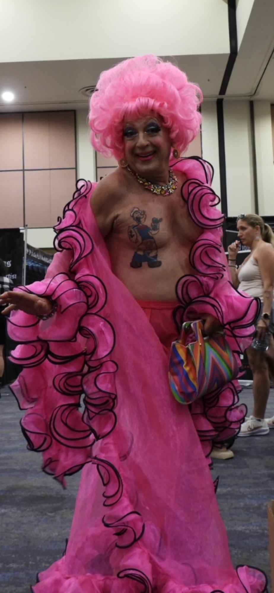 The Freedom to Be Misunderstood — Self Expression, Judgment, and the Courage to Be Seen A convention portrait of Mis-behaven in pink attire with tattoos, reflecting self expression and being misunderstood in tattoo culture