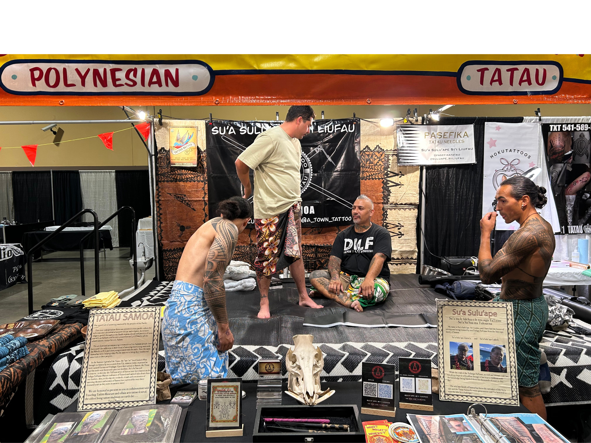 Traditional Polynesian Tatau artists at a tattoo convention booth, preserving cultural tattoo knowledge through live demonstration