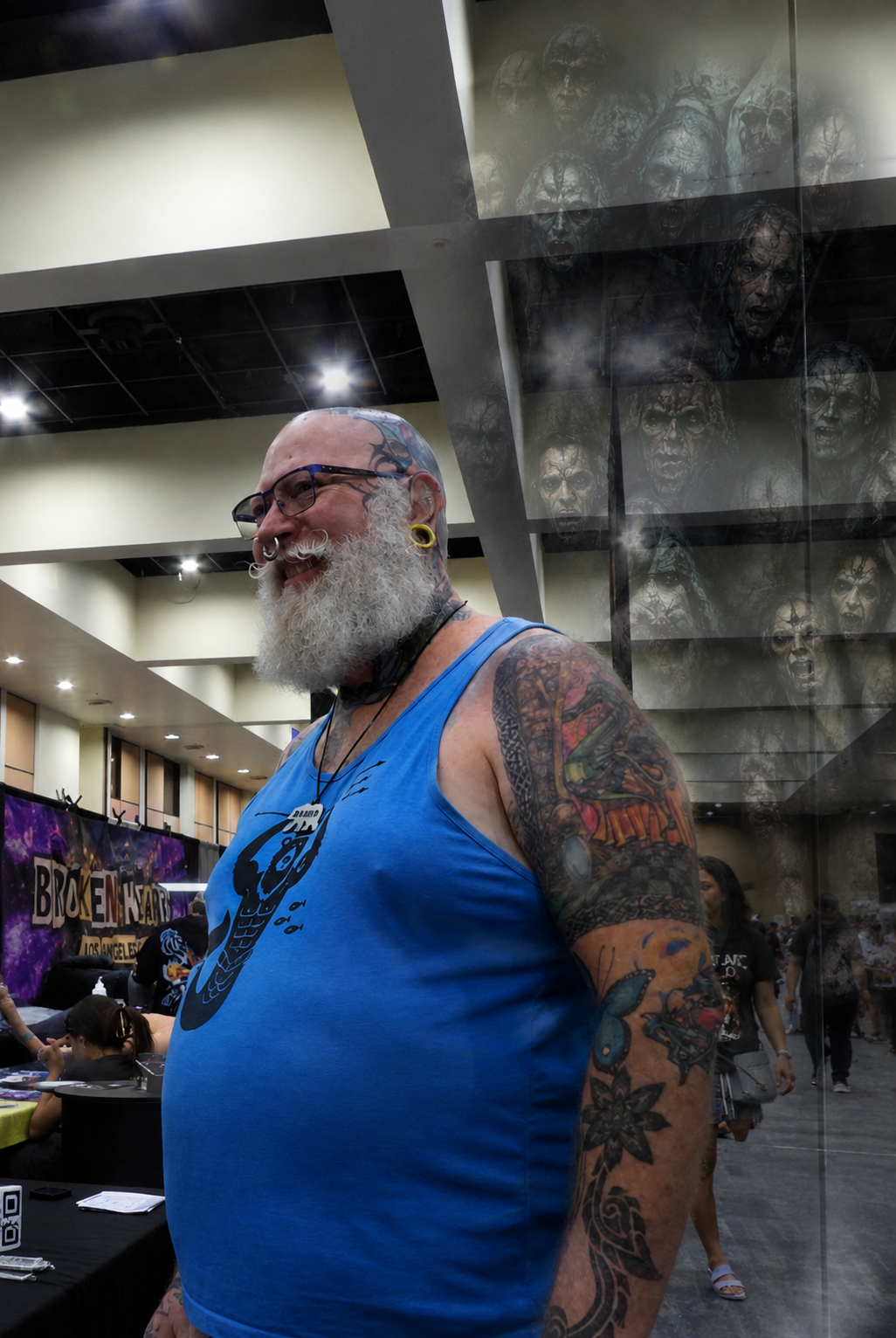 Tattooed convention attendee beside a layered montage of ominous faces, illustrating protective tattoos and beliefs about harmful spiritual forces
